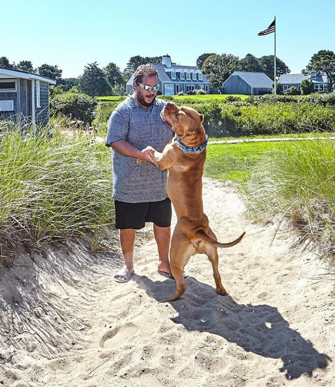 Evan Metropoulos with dog standing oppo